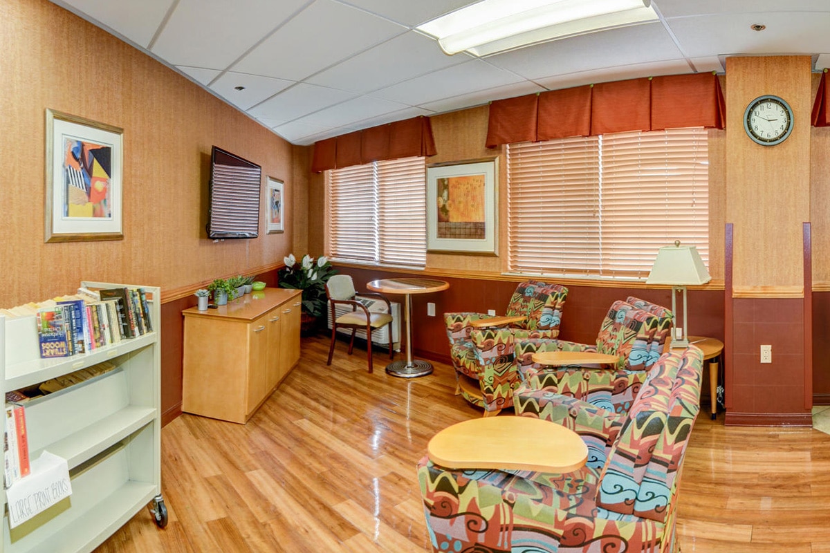 Activity room with books, comfy chairs and TV